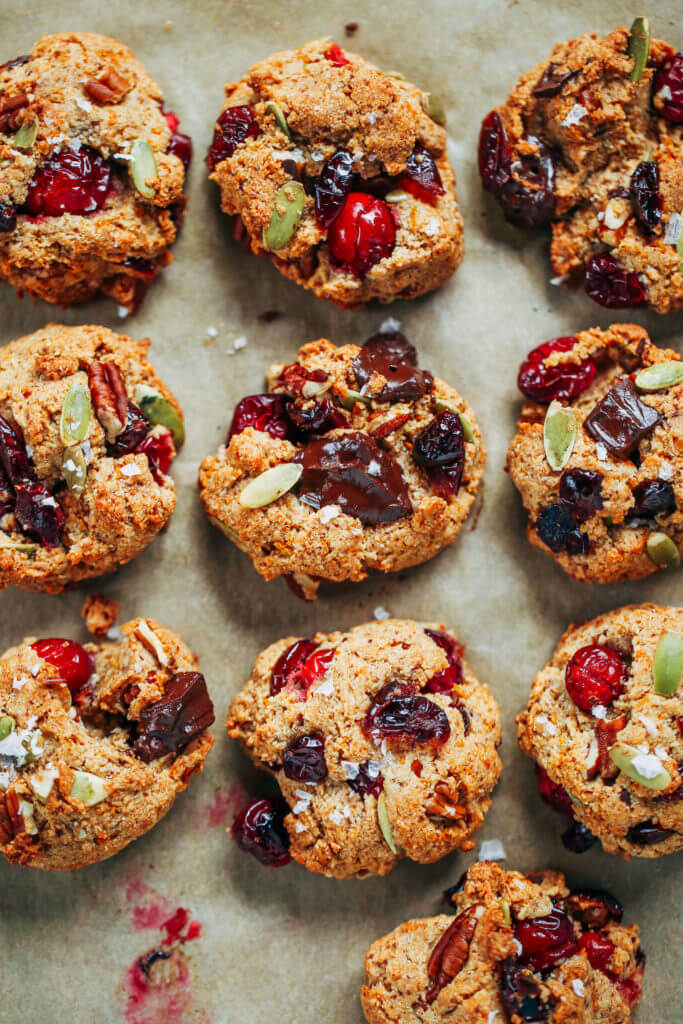 Perfect paleo kitchen sink cookies made with almond flour. Low sugar cookies that make holiday baking easy and delicious! Load them up with cranberries, chocolate, pecans, and seeds! My favorite paleo gluten free cookie recipe- it also happens to be an egg free cookie! #cookies #baking #paleo #almondflour #glutenfree #dessert