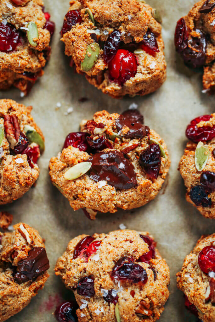 Perfect paleo kitchen sink cookies made with almond flour. Low sugar cookies that make holiday baking easy and delicious! Load them up with cranberries, chocolate, pecans, and seeds! My favorite paleo gluten free cookie recipe- it also happens to be an egg free cookie! #cookies #baking #paleo #almondflour #glutenfree #dessert