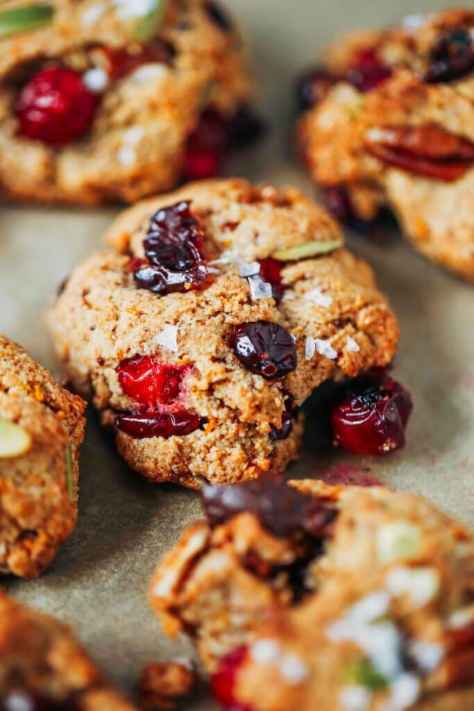 Perfect paleo kitchen sink cookies made with almond flour. Low sugar cookies that make holiday baking easy and delicious! Load them up with cranberries, chocolate, pecans, and seeds! My favorite paleo gluten free cookie recipe- it also happens to be an egg free cookie! #cookies #baking #paleo #almondflour #glutenfree #dessert