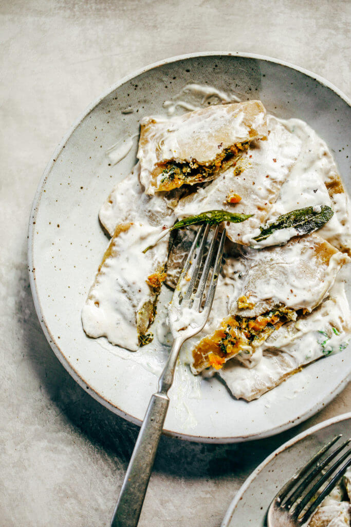 2 Ingredient ravioli made with sweet potato! Filled with butternut kale sage filling and served with cream sauce. A delicious paleo family dinner the whole family will love! Paleo pasta recipe made with white sweet potato. #pasta #paleodiet #healthydinners #mealprep #kale