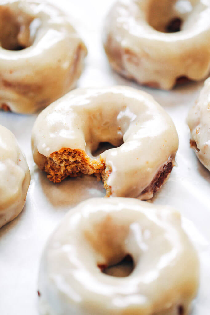 Ready for this fall favorite? Paleo pumpkin pie glazed donuts- made with white sweet potato instead of flour... It truly doesn't get any better! The texture is soft and fluffy, the flavor is pumpkin pie in real life, and the glaze is EVERYTHING. Easy gluten free donut recipe. Best paleo baked donuts! #paleo #donuts #pumpkinspice #baking