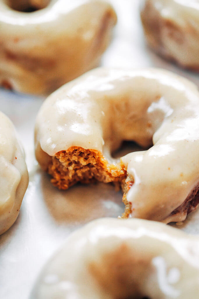 Ready for this fall favorite? Paleo pumpkin pie glazed donuts- made with white sweet potato instead of flour... It truly doesn't get any better! The texture is soft and fluffy, the flavor is pumpkin pie in real life, and the glaze is EVERYTHING. Easy gluten free donut recipe. Best paleo baked donuts! #paleo #donuts #pumpkinspice #baking