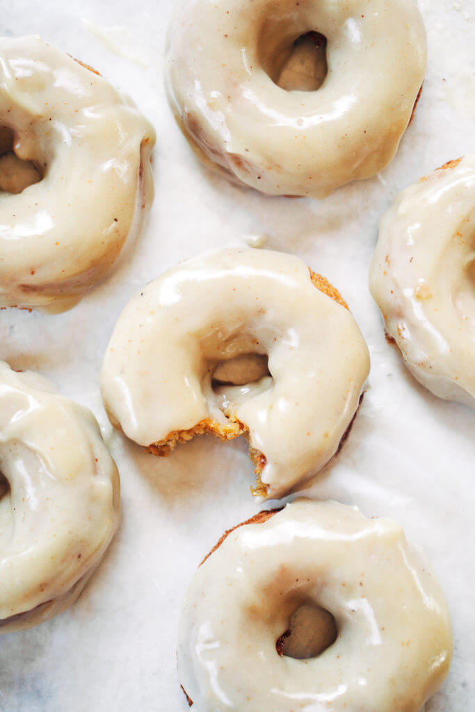 Ready for this fall favorite? Paleo pumpkin pie glazed donuts- made with white sweet potato instead of flour... It truly doesn't get any better! The texture is soft and fluffy, the flavor is pumpkin pie in real life, and the glaze is EVERYTHING. Easy gluten free donut recipe. Best paleo baked donuts! #paleo #donuts #pumpkinspice #baking