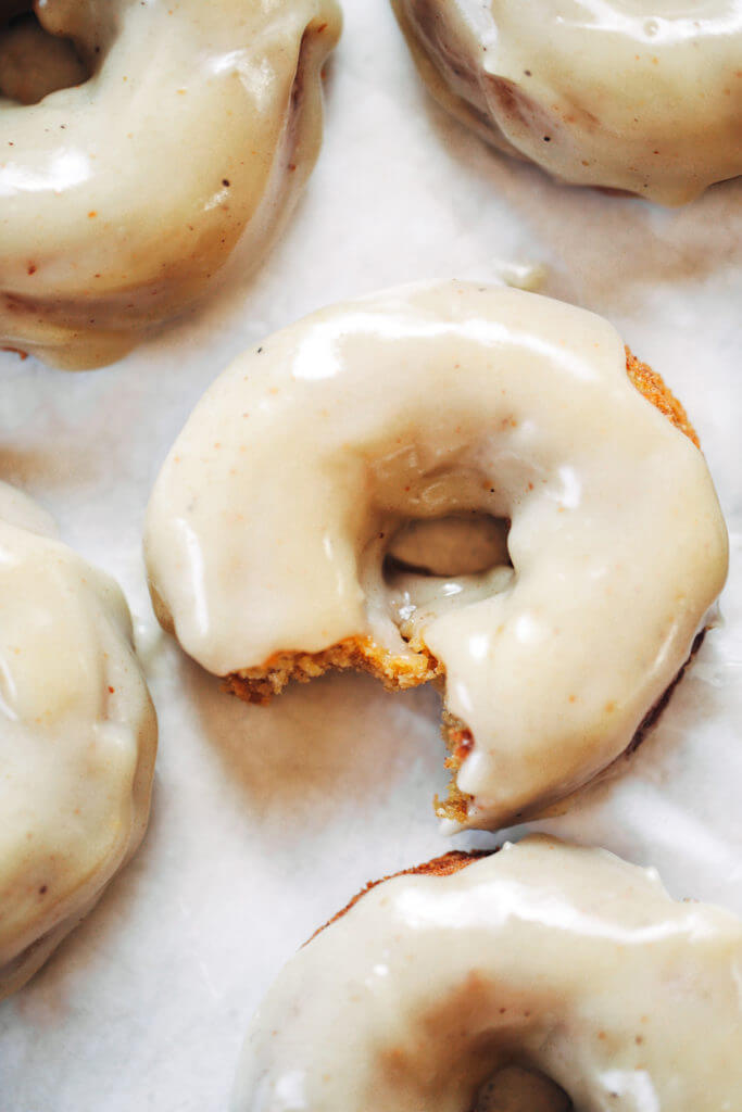 Ready for this fall favorite? Paleo pumpkin pie glazed donuts- made with white sweet potato instead of flour... It truly doesn't get any better! The texture is soft and fluffy, the flavor is pumpkin pie in real life, and the glaze is EVERYTHING. Easy gluten free donut recipe. Best paleo baked donuts! #paleo #donuts #pumpkinspice #baking