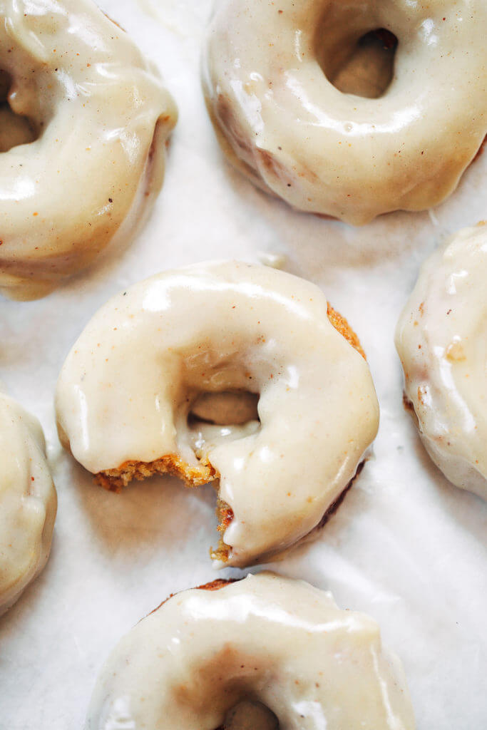 Ready for this fall favorite? Paleo pumpkin pie glazed donuts- made with white sweet potato instead of flour... It truly doesn't get any better! The texture is soft and fluffy, the flavor is pumpkin pie in real life, and the glaze is EVERYTHING. Easy gluten free donut recipe. Best paleo baked donuts! #paleo #donuts #pumpkinspice #baking