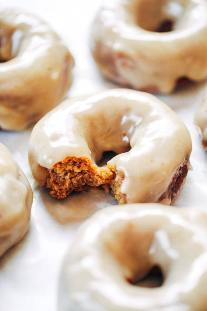 Ready for this fall favorite? Paleo pumpkin pie glazed donuts- made with white sweet potato instead of flour... It truly doesn't get any better! The texture is soft and fluffy, the flavor is pumpkin pie in real life, and the glaze is EVERYTHING. Easy gluten free donut recipe. Best paleo baked donuts! #paleo #donuts #pumpkinspice #baking