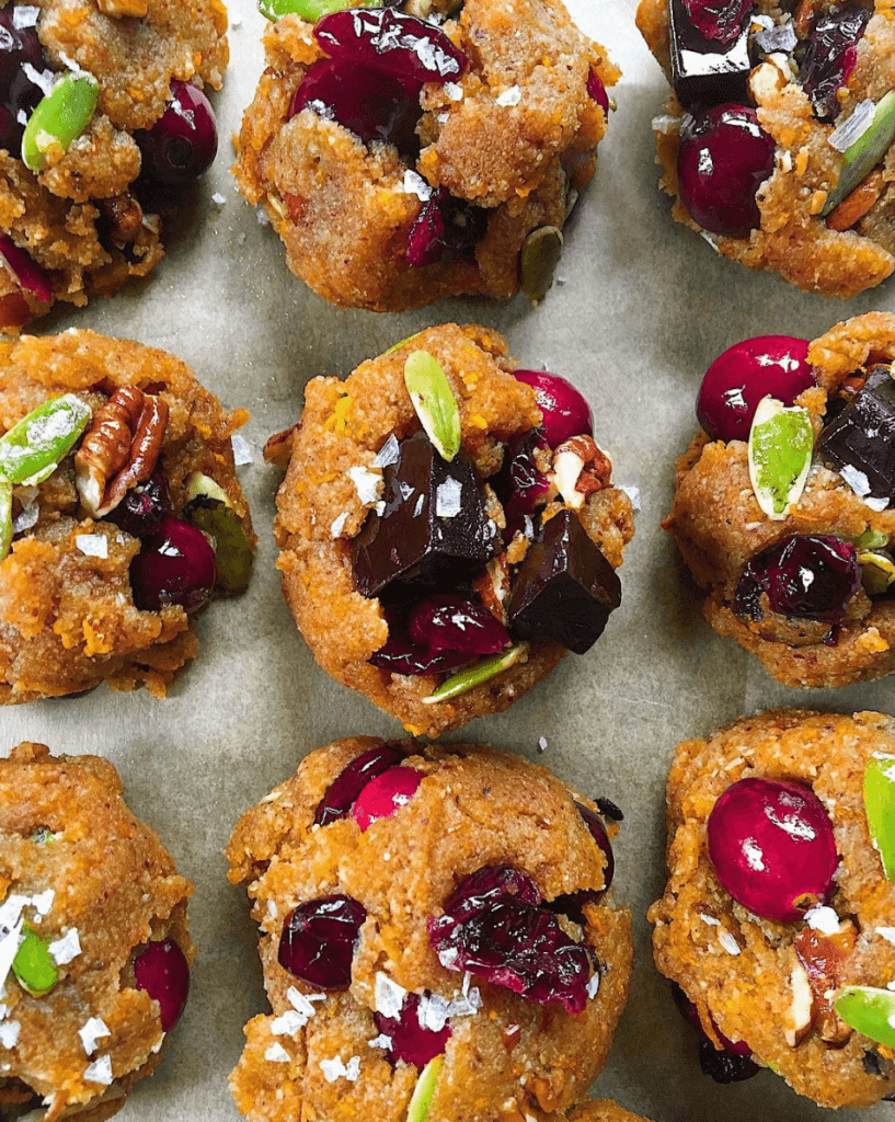 Perfect paleo kitchen sink cookies made with almond flour. Low sugar cookies that make holiday baking easy and delicious! Load them up with cranberries, chocolate, pecans, and seeds! My favorite paleo gluten free cookie recipe- it also happens to be an egg free cookie! #cookies #baking #paleo #almondflour #glutenfree #dessert