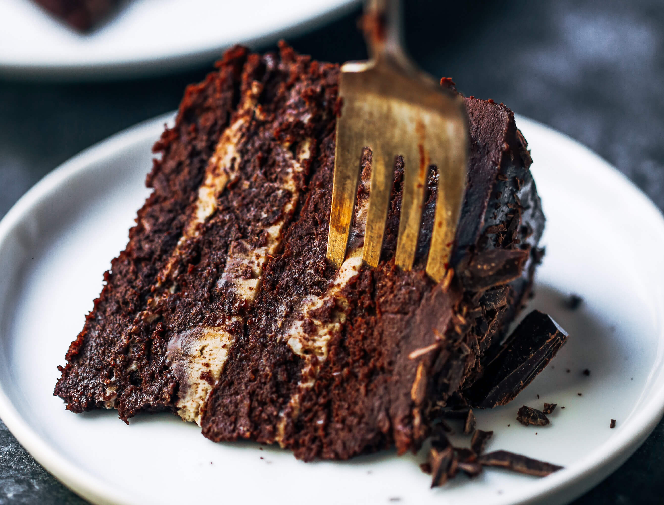 Fudgey paleo chocolate cake made without flour! This low calorie chocolate cake is decadent and frosted with 2 ingredient chocolate frosting. So good! You have to try this paleo gluten free cake for birthdays, celebrations, and dessert time! Love this easy paleo chocolate cake the tastes like brownies with frosting! #chocolatecake #cake #paleodiet #paleo #healthydessert #brownies