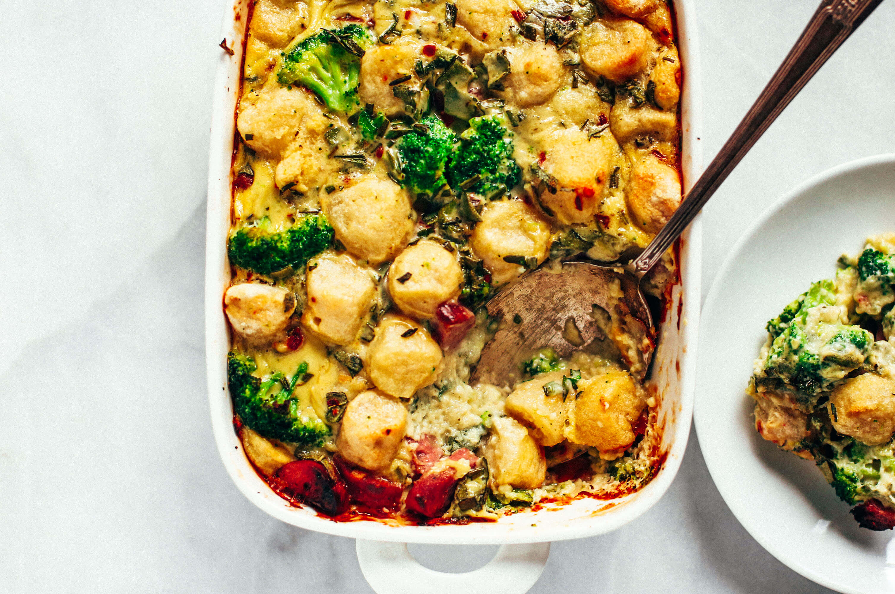Baked cauliflower gnocchi casserole- made with homemade two ingredient cauliflower gnocchi and rosemary sage cream sauce. Paleo, gluten free, and dairy free family dinner. This casserole is perfect for breakfast or dinner! Easy whole30 dinner recipes. Whole30 meal prep. Best paleo dinners. #paleo