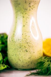 Creamy lemon garlic dressing is both whole30 and paleo. This easy dairy free salad dressing tastes like ranch dressing and is made with coconut milk! A healthy oil-free paleo dressing recipe. #paleo #whole30 #cooking #recipes