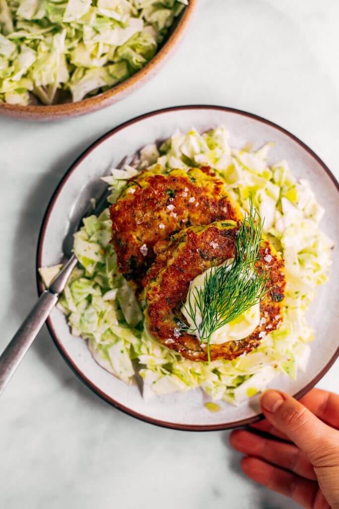 Whole30 salmon burgers with a side of slaw and zesty coconut milk lemon dill dressing. This easy paleo dinner recipe is perfect for meal prep and is SO easy to make! Lemon dill salmon burgers the whole family will love! #paleo #recipes #healthy #whole30