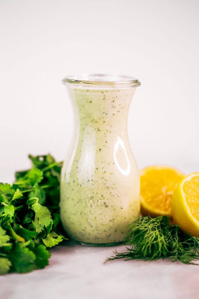 Creamy lemon garlic dressing is both whole30 and paleo. This easy dairy free salad dressing tastes like ranch dressing and is made with coconut milk! A healthy oil-free paleo dressing recipe. #paleo #whole30 #cooking #recipes