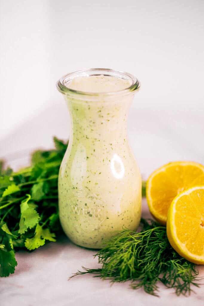 Creamy lemon garlic dressing is both whole30 and paleo. This easy dairy free salad dressing tastes like ranch dressing and is made with coconut milk! A healthy oil-free paleo dressing recipe. #paleo #whole30 #cooking #recipes