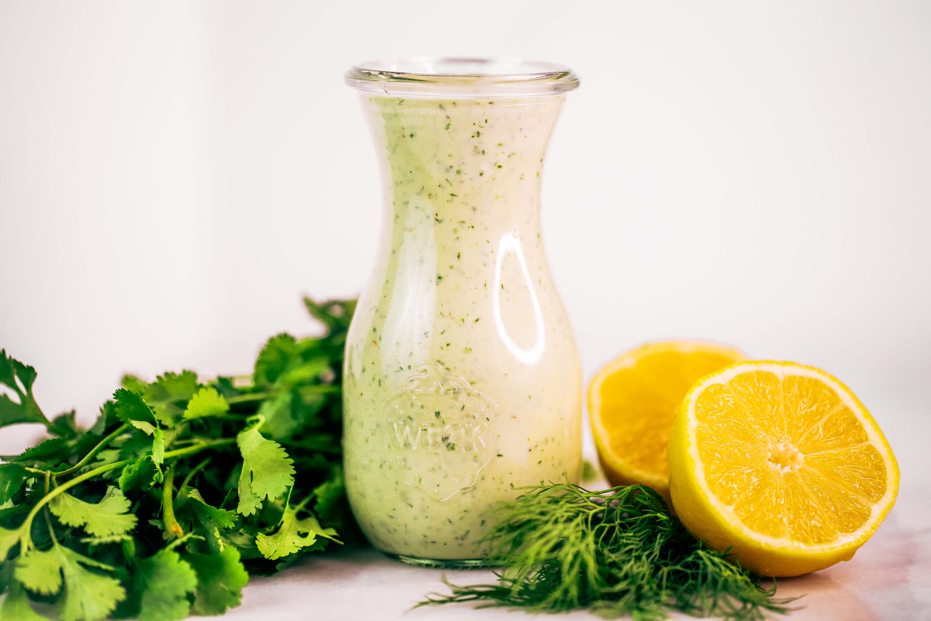 Creamy lemon garlic dressing is both whole30 and paleo. This easy dairy free salad dressing tastes like ranch dressing and is made with coconut milk! A healthy oil-free paleo dressing recipe. #paleo #whole30 #cooking #recipes