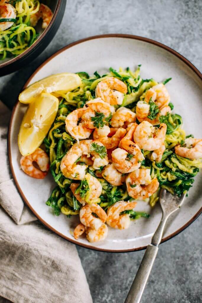 Whole30 zucchini noodles with lemon garlic shrimp. An easy and delicious weeknight dinner. Who’s ready for this healthy low calorie and filling paleo dinner? #paleo #whole30 #healthydinner