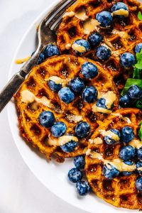 Sweet potato waffles made with two ingredients and ready in just five minutes! These sweet potato waffles are better than Eggos and can be made ahead and frozen for quick meal prep. Best paleo waffles for healthy eaters. Easy gluten free waffles for everyone!