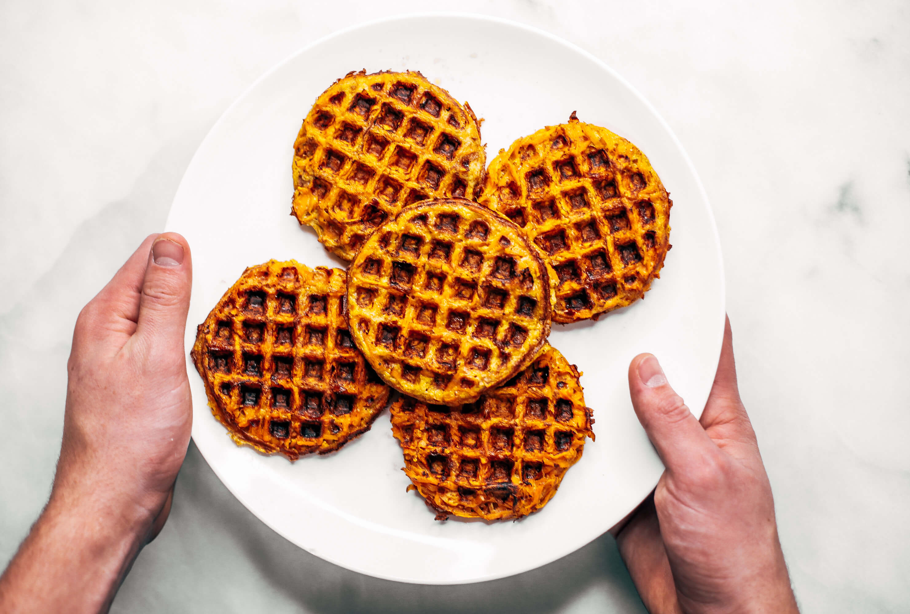 Sweet potato waffles made with two ingredients and ready in just five minutes! These sweet potato waffles are better than Eggos and can be made ahead and frozen for quick meal prep. Best paleo waffles for healthy eaters. Easy gluten free waffles for everyone!