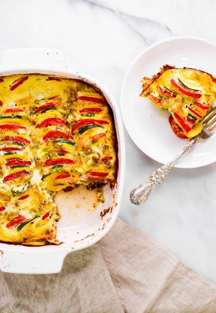 Easy whole30 egg and zucchini breakfast bake with tomatoes, yellow squash, herbs, and zucchini. This paleo breakfast is perfect for meal prep at the beginning of the week and paired with one of my homemade sweet potato tortillas! #paleo #whole30 #bacon