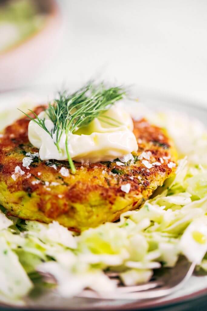 Whole30 salmon burgers with a side of slaw and zesty coconut milk lemon dill dressing. This easy paleo dinner recipe is perfect for meal prep and is SO easy to make! Lemon dill salmon burgers the whole family will love! #paleo #recipes #healthy #whole30