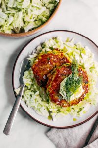 Whole30 salmon burgers with a side of slaw and zesty coconut milk lemon dill dressing. This easy paleo dinner recipe is perfect for meal prep and is SO easy to make! Lemon dill salmon burgers the whole family will love! #paleo #recipes #healthy #whole30