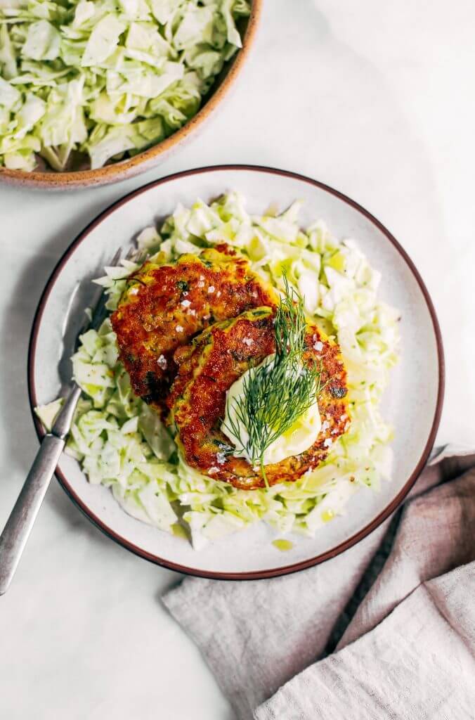 Whole30 salmon burgers with a side of slaw and zesty coconut milk lemon dill dressing. This easy paleo dinner recipe is perfect for meal prep and is SO easy to make! Lemon dill salmon burgers the whole family will love! #paleo #recipes #healthy #whole30