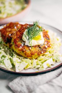 Whole30 salmon burgers with a side of slaw and zesty coconut milk lemon dill dressing. This easy paleo dinner recipe is perfect for meal prep and is SO easy to make! Lemon dill salmon burgers the whole family will love! #paleo #recipes #healthy #whole30