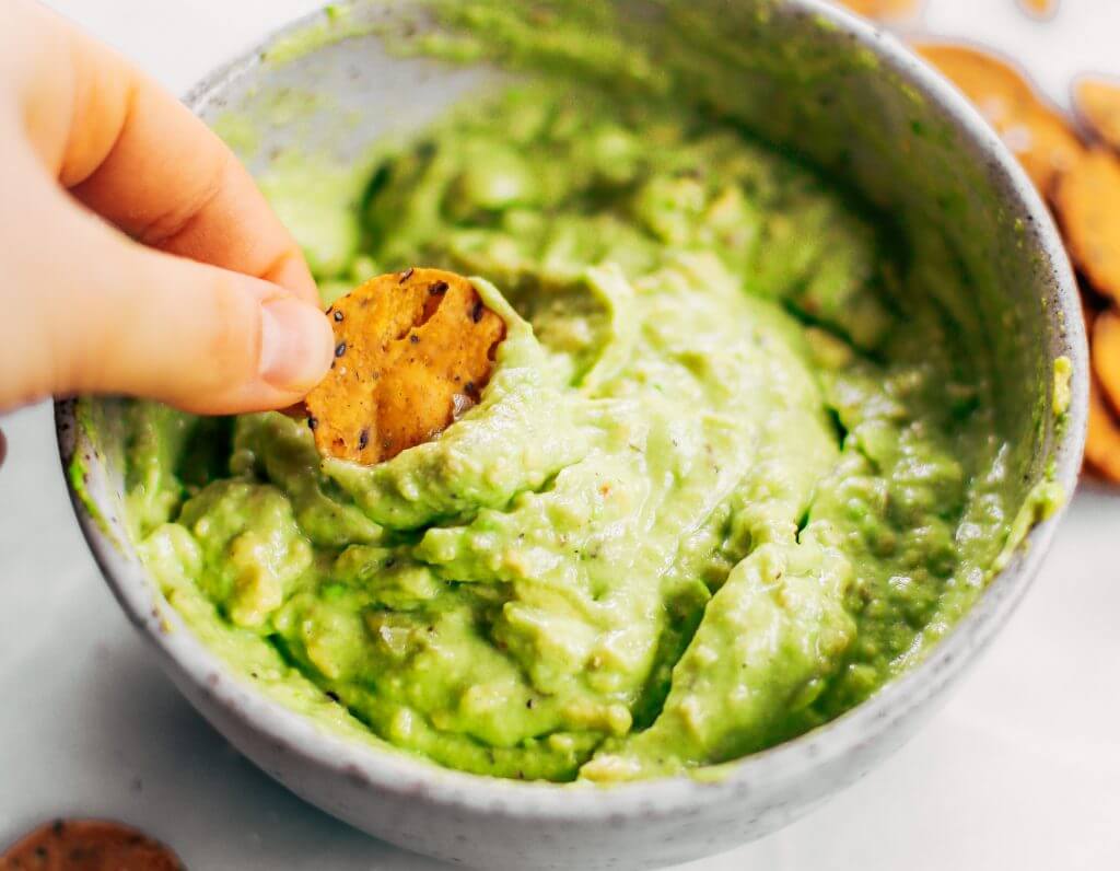 Avocado lime dip ready in two minutes! Vegan avocado guacamole dip, perfect dip for veggie sticks, crackers, and chips. Easy paleo and whole30 side dish. This fresh and tasty avocado dip is a life-changing easy meal prep hack- add it to any dish to upgrade your meal. #avocado #paleo #whole30 #vegan #recipes