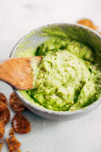 Avocado lime dip ready in two minutes! Vegan avocado guacamole dip, perfect dip for veggie sticks, crackers, and chips. Easy paleo and whole30 side dish. This fresh and tasty avocado dip is a life-changing easy meal prep hack- add it to any dish to upgrade your meal. #avocado #paleo #whole30 #vegan #recipes