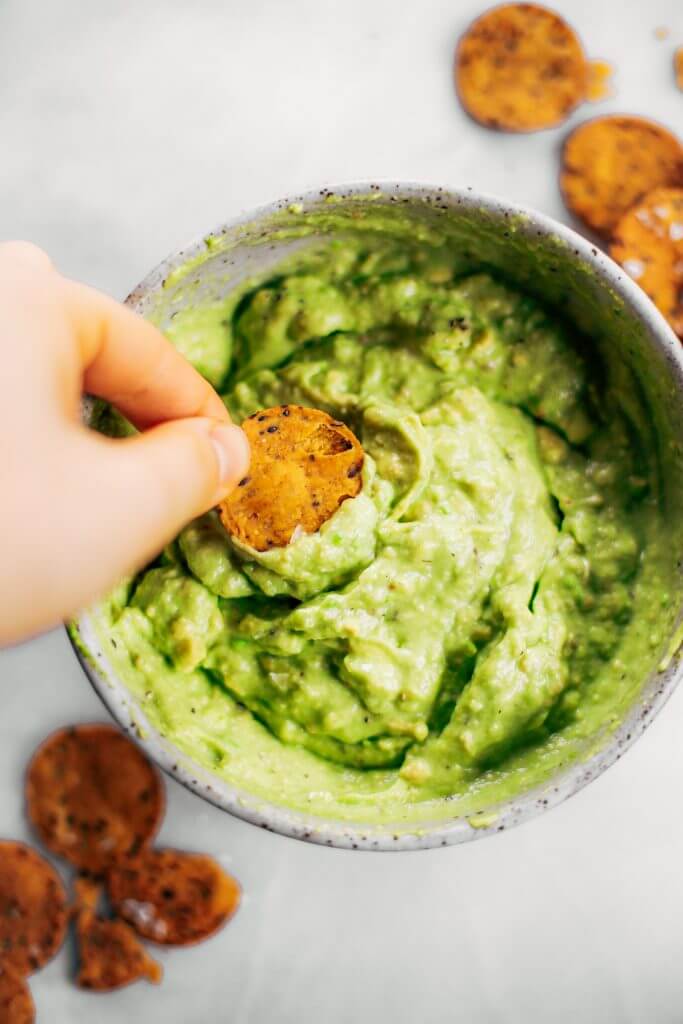 Avocado lime dip ready in two minutes! Vegan avocado guacamole dip, perfect dip for veggie sticks, crackers, and chips. Easy paleo and whole30 side dish. This fresh and tasty avocado dip is a life-changing easy meal prep hack- add it to any dish to upgrade your meal. #avocado #paleo #whole30 #vegan #recipes