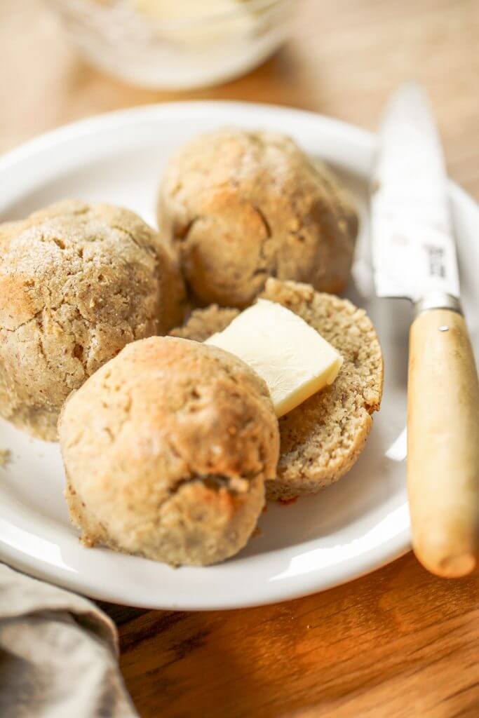 Homemade dinner rolls made with almond flour. These healthier paleo bread rolls are so easy to make and have no yeast! It's an easy gluten free bread recipe that the whole family will love. Perfect for serving with soup for dinner or with eggs for breakfast. #paleo #bread #baking #recipes #cooking