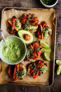 Easy vegan fajita smashed potatoes. This easy whole30 and paleo sheet pan dinner is delicious served with creamy avocado lime dip. Smashed baked sweet potatoes with fajita seasoned bell peppers.