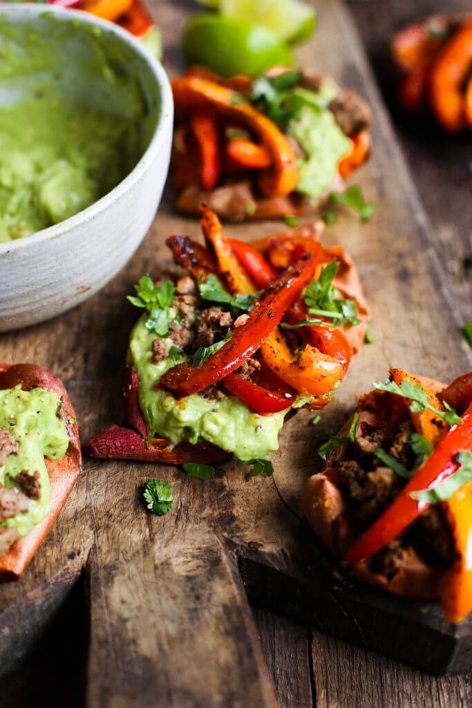 Easy vegan fajita smashed potatoes. This easy whole30 and paleo sheet pan dinner is delicious served with creamy avocado lime dip. Smashed baked sweet potatoes with fajita seasoned bell peppers.