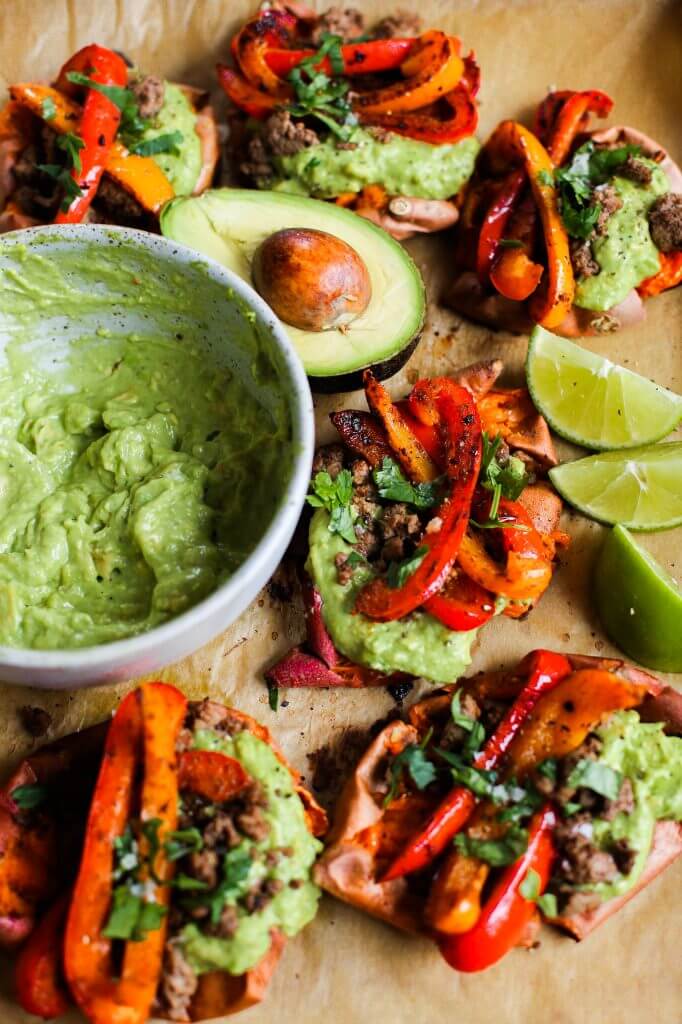 Easy vegan fajita smashed potatoes. This easy whole30 and paleo sheet pan dinner is delicious served with creamy avocado lime dip. Smashed baked sweet potatoes with fajita seasoned bell peppers.
