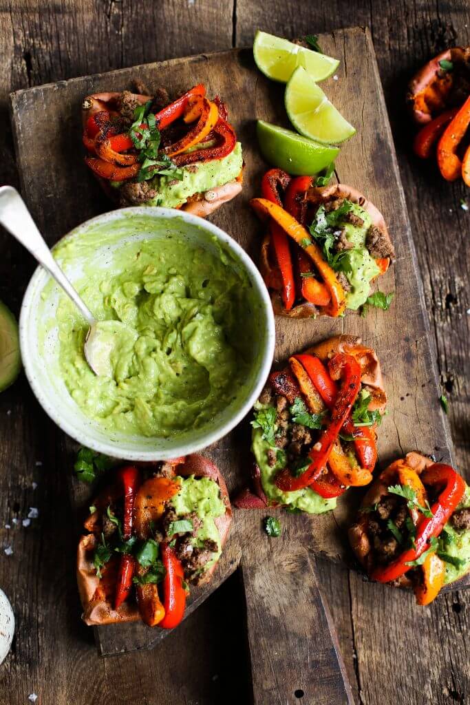 Easy vegan fajita smashed potatoes. This easy whole30 and paleo sheet pan dinner is delicious served with creamy avocado lime dip. Smashed baked sweet potatoes with fajita seasoned bell peppers.