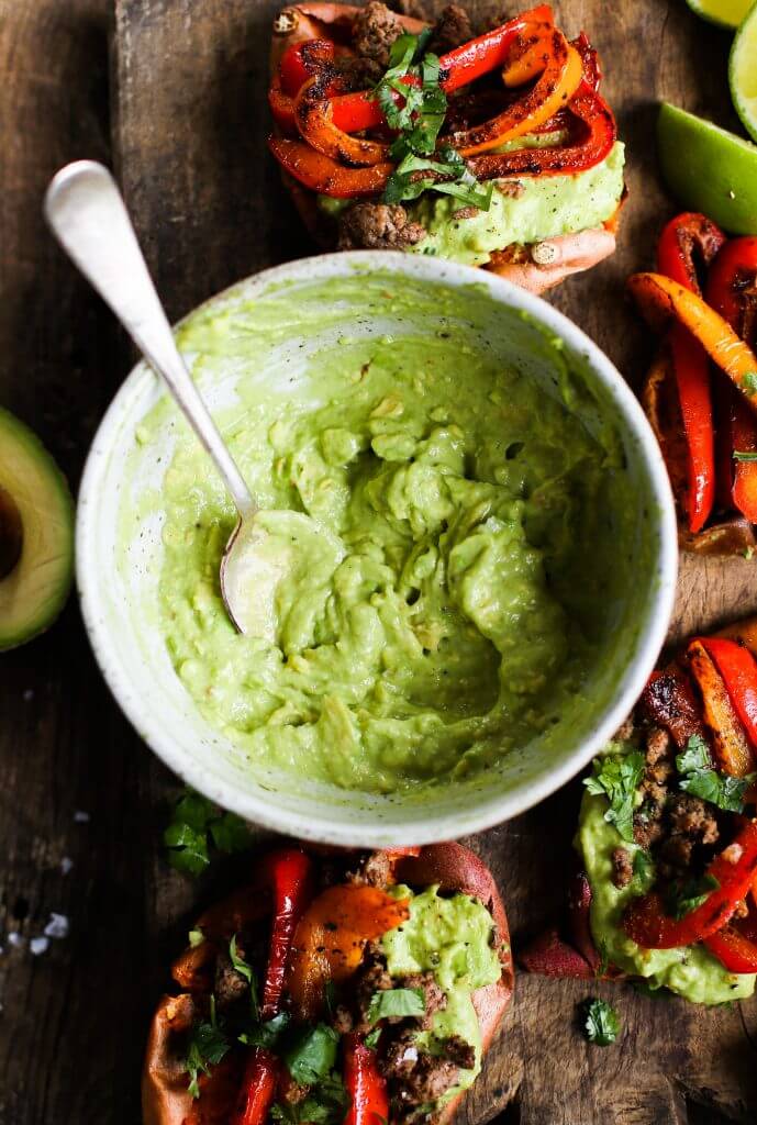 Easy vegan fajita smashed potatoes. This easy whole30 and paleo sheet pan dinner is delicious served with creamy avocado lime dip. Smashed baked sweet potatoes with fajita seasoned bell peppers.