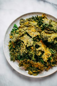 Zesty lemon garlic kale chips. Homemade kale chip recipe. Easy whole30 snack for on the go. These healthy paleo kale chips are made with just a few ingredients and are SO easy to make! #whole30 #paleo #vegan #recipe #cooking