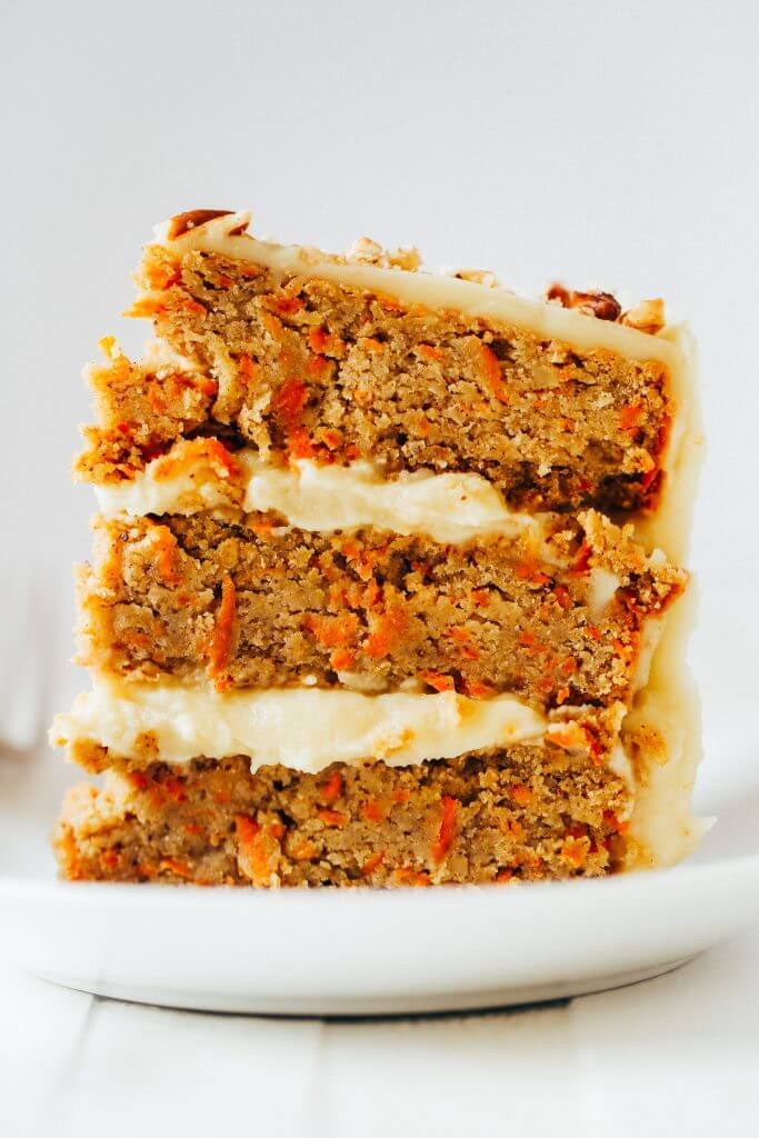 Paleo carrot cake made with sweet potatoes. Topped with creamy lemon frosting made from white sweet potatoes. A healthy carrot cake recipe that is gluten free and dairy free. Moist and flavorful carrot cake perfect for spring! #cake #baking #paleo #recipes