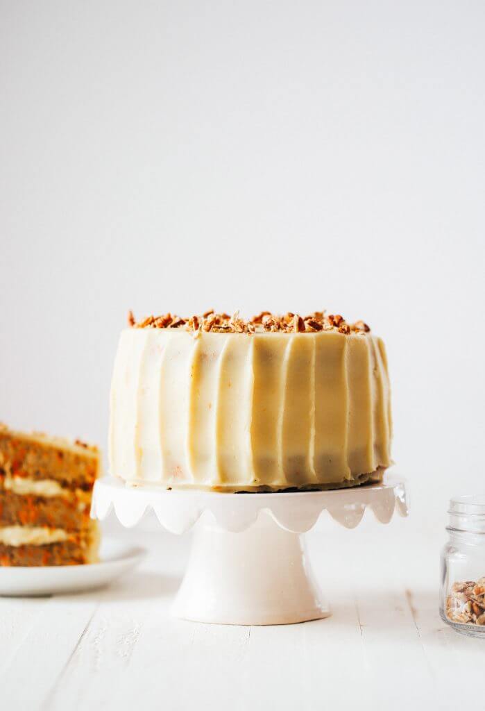 Paleo carrot cake made with sweet potatoes. Topped with creamy lemon frosting made from white sweet potatoes. A healthy carrot cake recipe that is gluten free and dairy free. Moist and flavorful carrot cake perfect for spring! #cake #baking #paleo #recipes