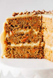 Paleo carrot cake made with sweet potatoes. Topped with creamy lemon frosting made from white sweet potatoes. A healthy carrot cake recipe that is gluten free and dairy free. Moist and flavorful carrot cake perfect for spring! #cake #baking #paleo #recipes