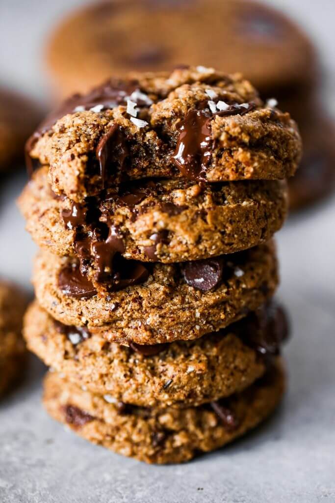 Paleo chocolate chip cookies made with hazelnut flour. Thick and soft cookies with gooey chocolate in the center. An easy paleo cookie recipe for dessert time! You can even make ahead and freeze for later. #cookies #paleo #baking #recipes #dessert #chocolate