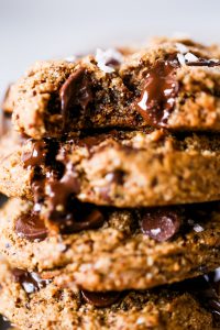 Paleo chocolate chip cookies made with hazelnut flour. Thick and soft cookies with gooey chocolate in the center. An easy paleo cookie recipe for dessert time! You can even make ahead and freeze for later. #cookies #paleo #baking #recipes #dessert #chocolate