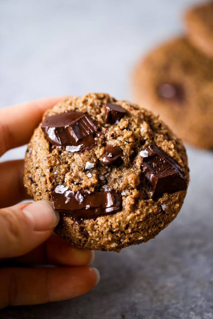 Paleo chocolate chip cookies made with hazelnut flour. Thick and soft cookies with gooey chocolate in the center. An easy paleo cookie recipe for dessert time! You can even make ahead and freeze for later. #cookies #paleo #baking #recipes #dessert #chocolate