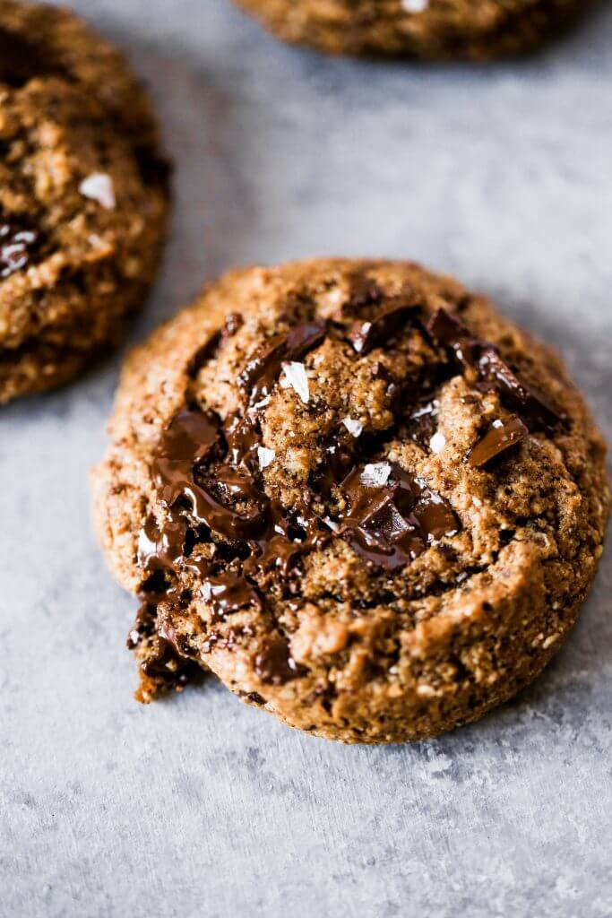 Paleo chocolate chip cookies made with hazelnut flour. Thick and soft cookies with gooey chocolate in the center. An easy paleo cookie recipe for dessert time! You can even make ahead and freeze for later. #cookies #paleo #baking #recipes #dessert #chocolate