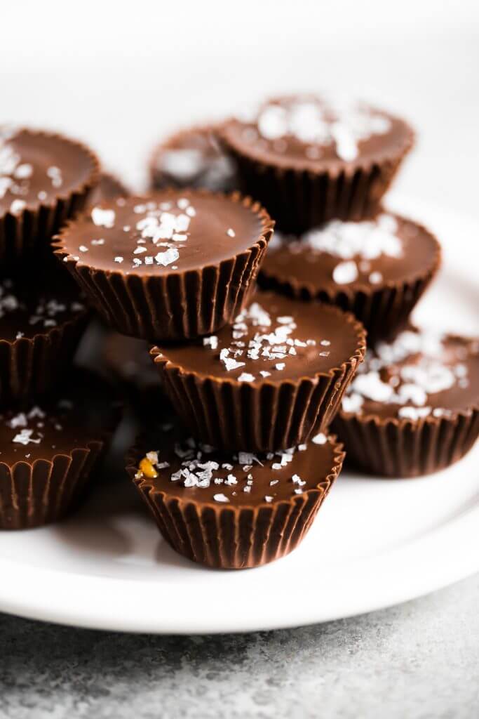 Healthier chocolate peanut butter cups. Make at home with this easy and fast recipe! See directions for a paleo version too. You’re not gonna want to go back, once you have tasted these. Enjoy! #dessert #baking #recipes #paleo #chocolate #vegan