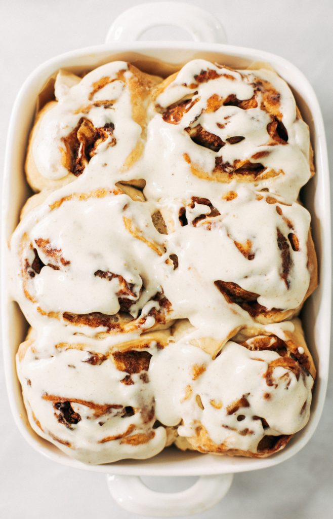 Fluffy Vegan Cinnamon Rolls made with coconut oil, almond milk, and no refined sugar! These healthier cinnamon rolls are light, fluffy, gooey, and delicious. You can make these vegan with cashew cream cheese frosting- yum!