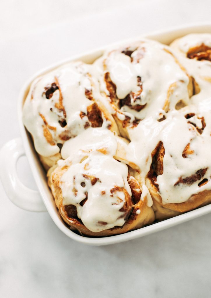 Fluffy Vegan Cinnamon Rolls made with coconut oil, almond milk, and no refined sugar! These healthier cinnamon rolls are light, fluffy, gooey, and delicious. You can make these vegan with cashew cream cheese frosting- yum!